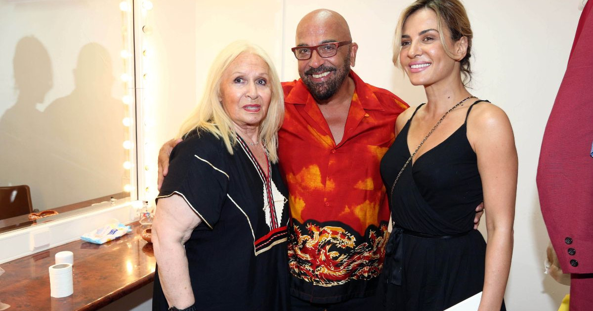 Betty Valasi, Giannis Zouganelis and a woman posing together backstage indoors